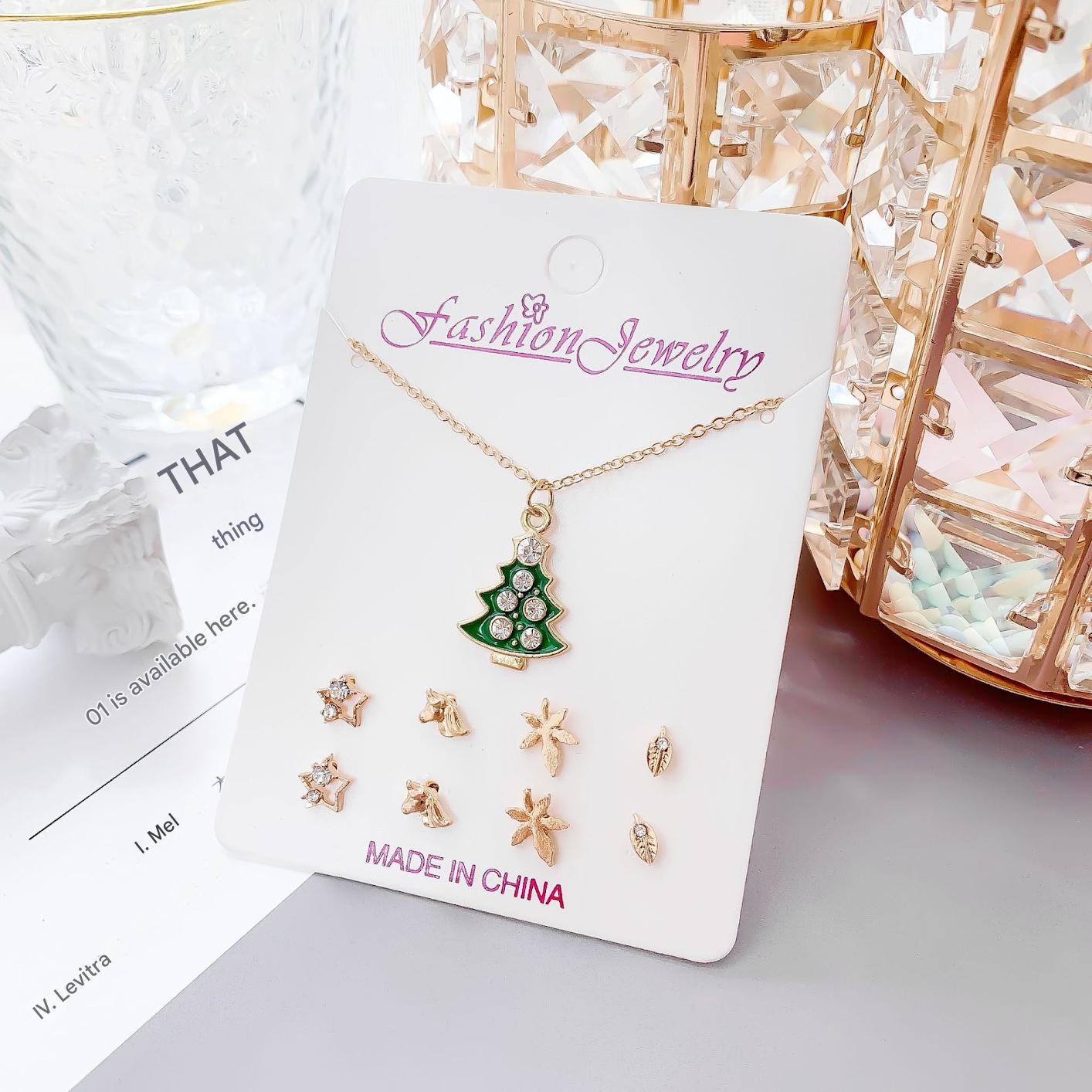 Gold snowman necklace against a white background
