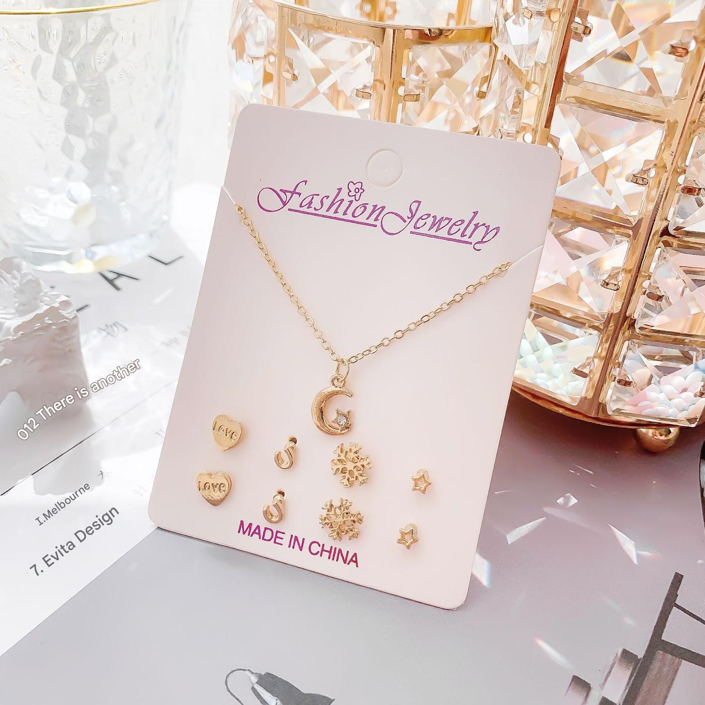 Gold-plated minimalistic necklace on a white display