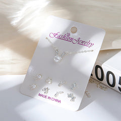 Playful moon and snowman themed earrings close-up