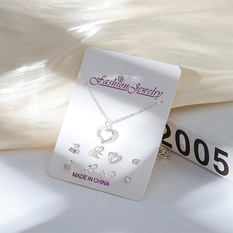 Gold alloy earrings alongside the matching necklace