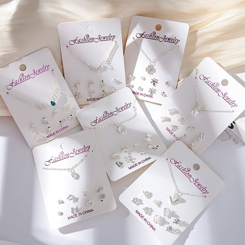 Close-up of gold crystal earrings with snowman design
