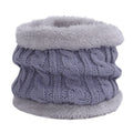 Knit hat and scarf set laid out on a snowy background