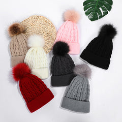 White knit beanie with stylish pom pom accent