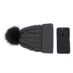 Dark grey knit beanie with pom pom displayed