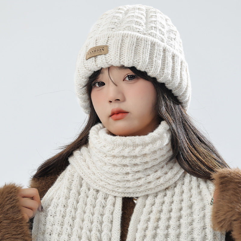 Beige knit hat and scarf set displayed on a white background