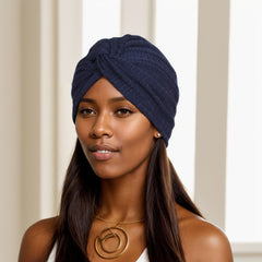 black twist headwrap beanie placed on a wooden table