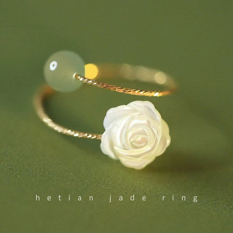 Elegant rose flower ring against a neutral background