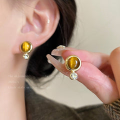 Teardrop design tiger eye earrings displayed
