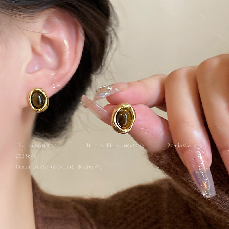 Pair of tiger eye earrings on model