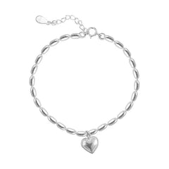 Versatile heart charm bracelet on a neutral background