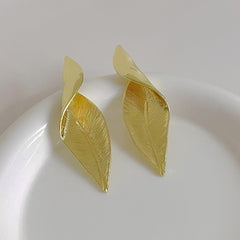 Silver leaf statement earrings worn by model