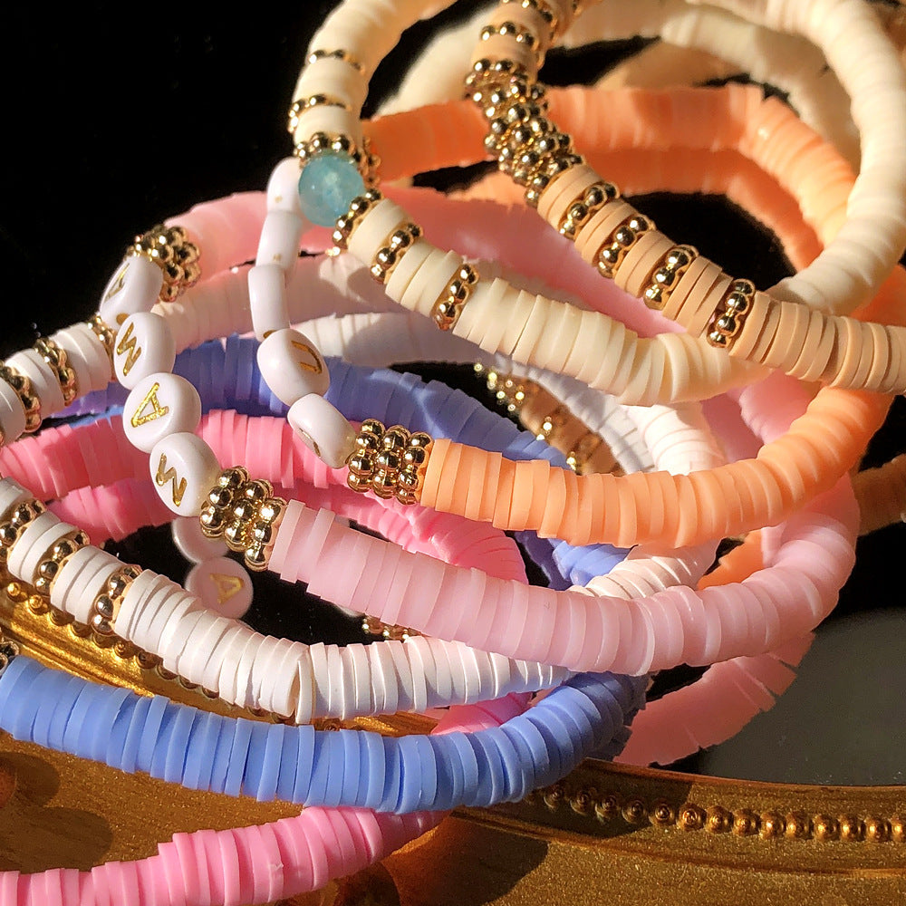 Colorful charm bracelet worn by a model outdoors