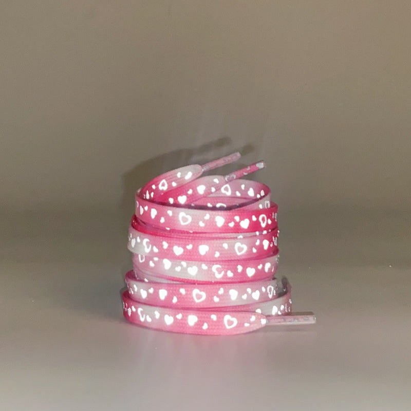 Mint green reflective shoelaces displayed on shoes