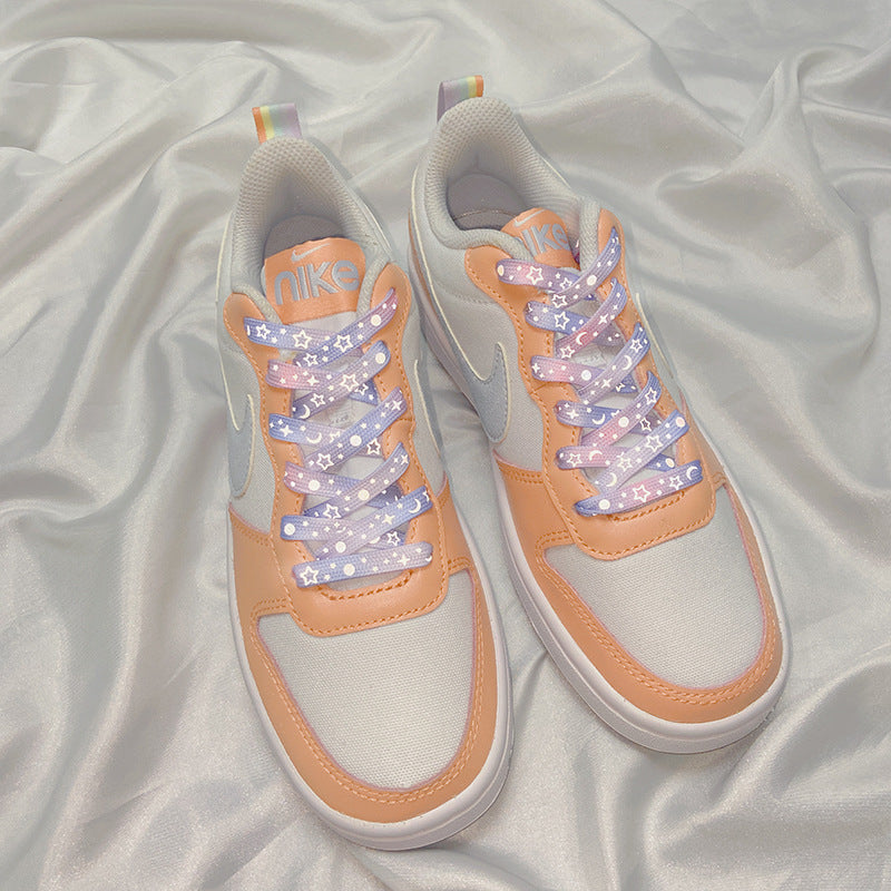 Red-pink reflective shoelaces on casual footwear