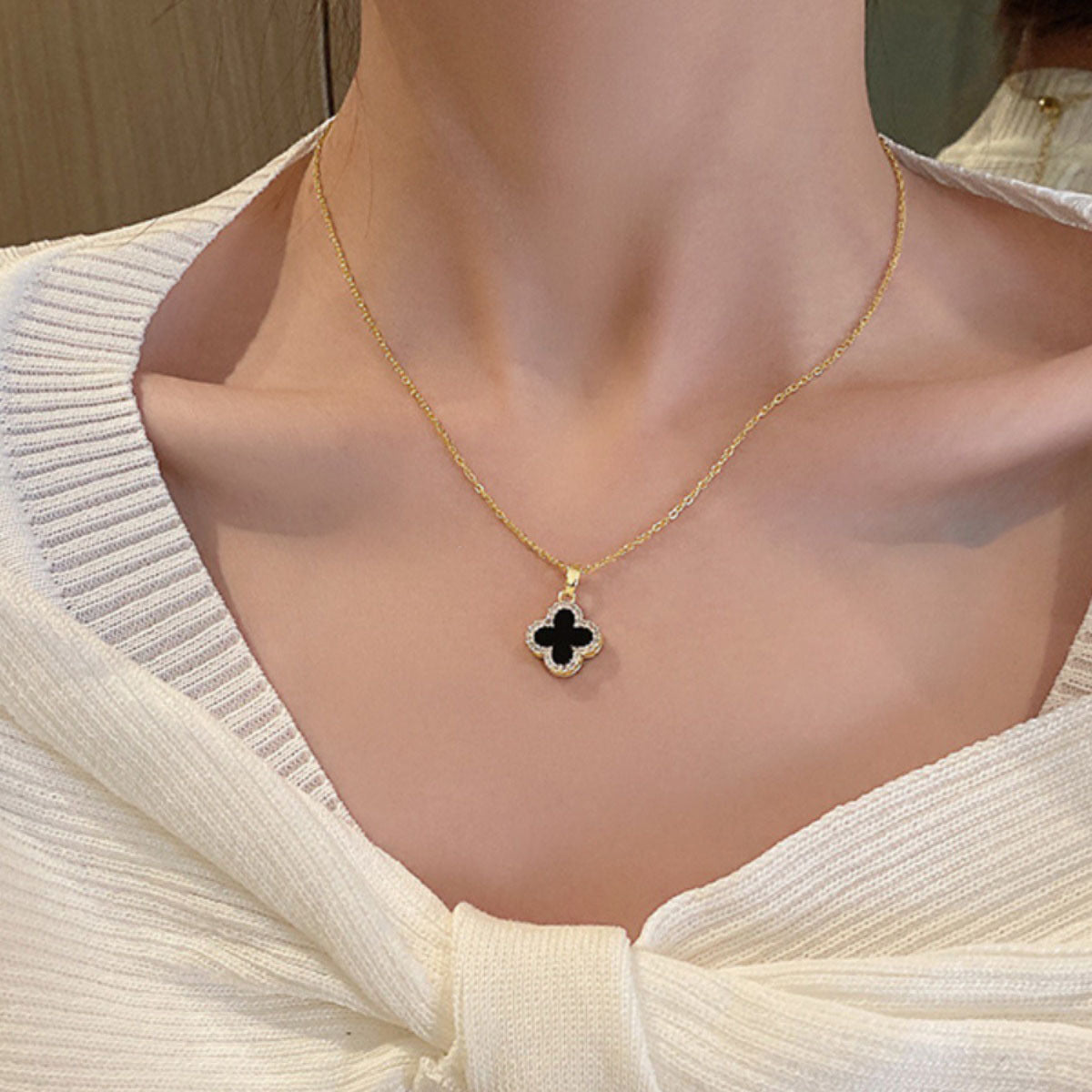Close-up details of the four-leaf clover pendant