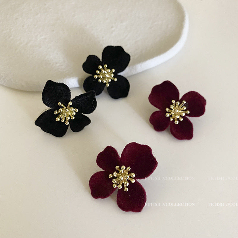 Premium Velvet Floral Earrings against a floral backdrop