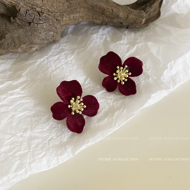 Premium Velvet Floral Earrings against a floral backdrop