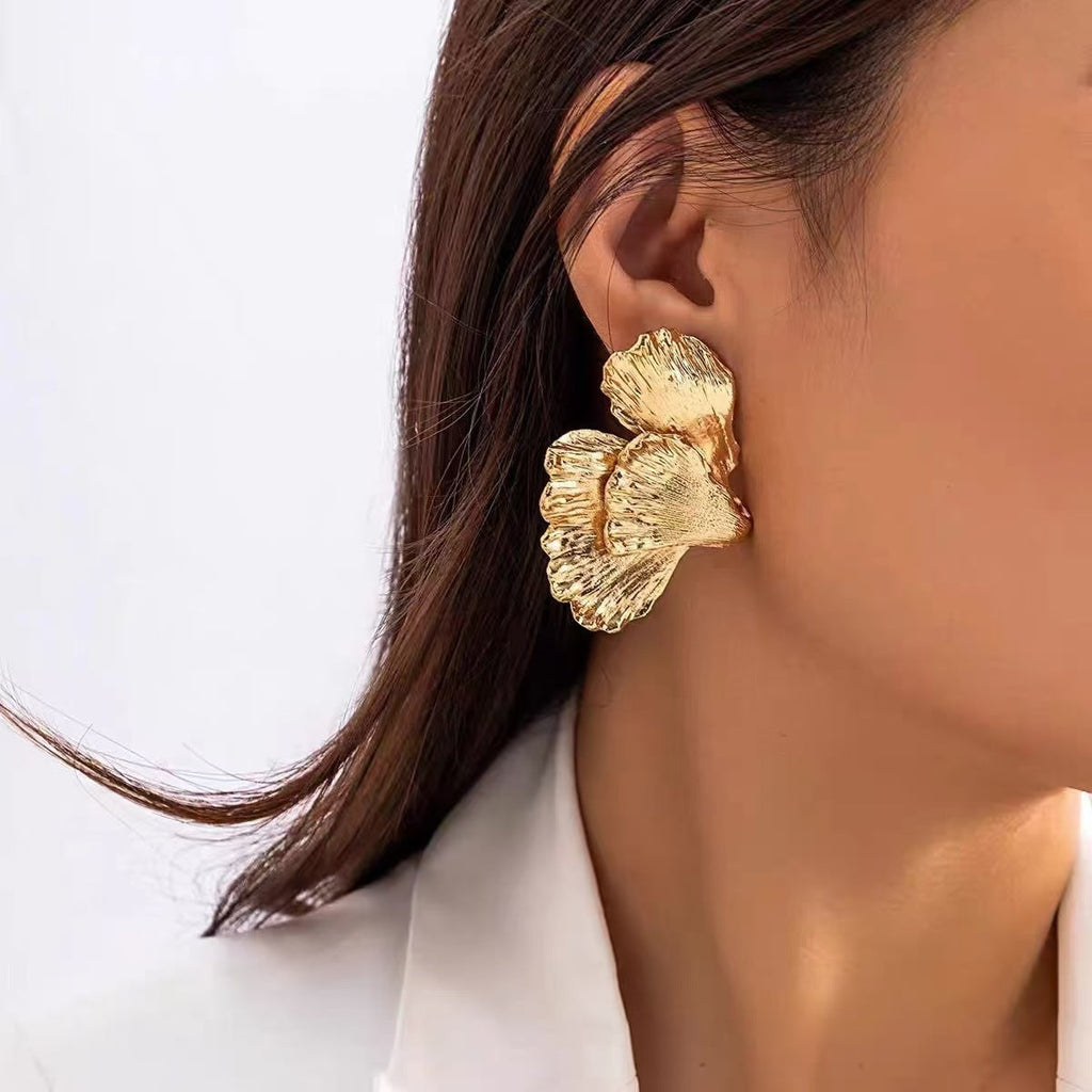 Elegant leaf earrings styled on white background