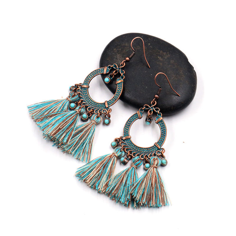 close-up of tassel earrings highlighting details