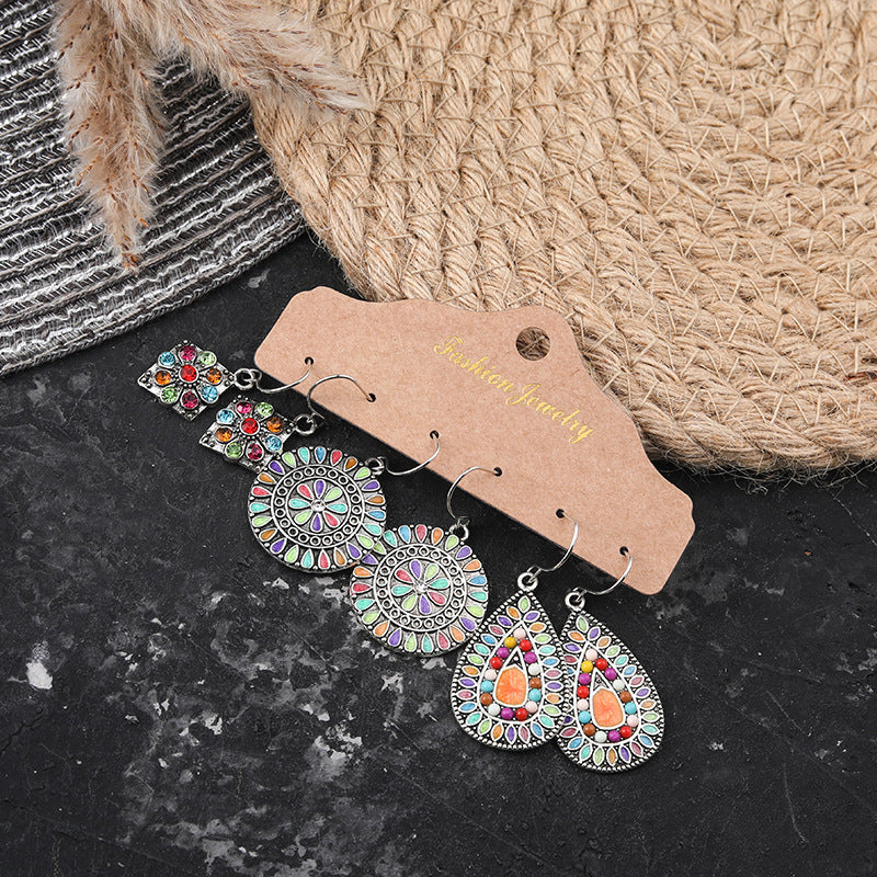 Geometric tassel earrings shown in three pairs