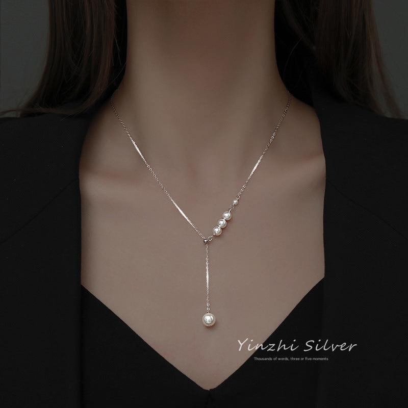 Tassel pearl necklace against a soft background