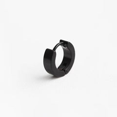Black geometric titanium earrings on display