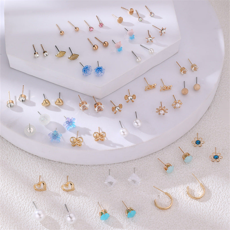 Pearl stud earrings on soft textile