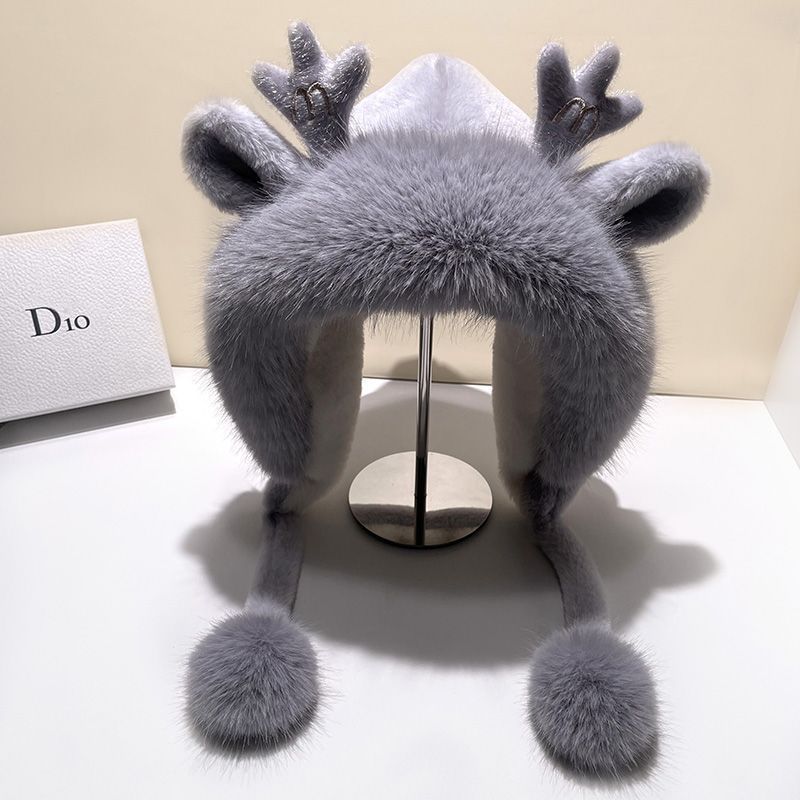 Stylish winter hat with antlers and pom poms side view