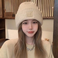 Cozy women's knit beanie in cream colour
