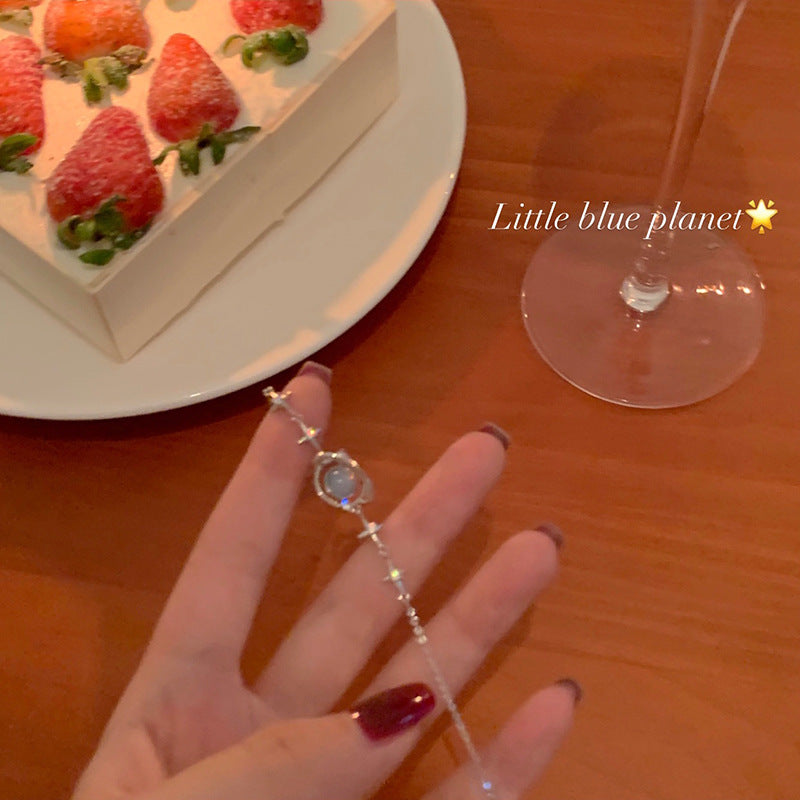 blue planet bracelet displayed in a casual setting