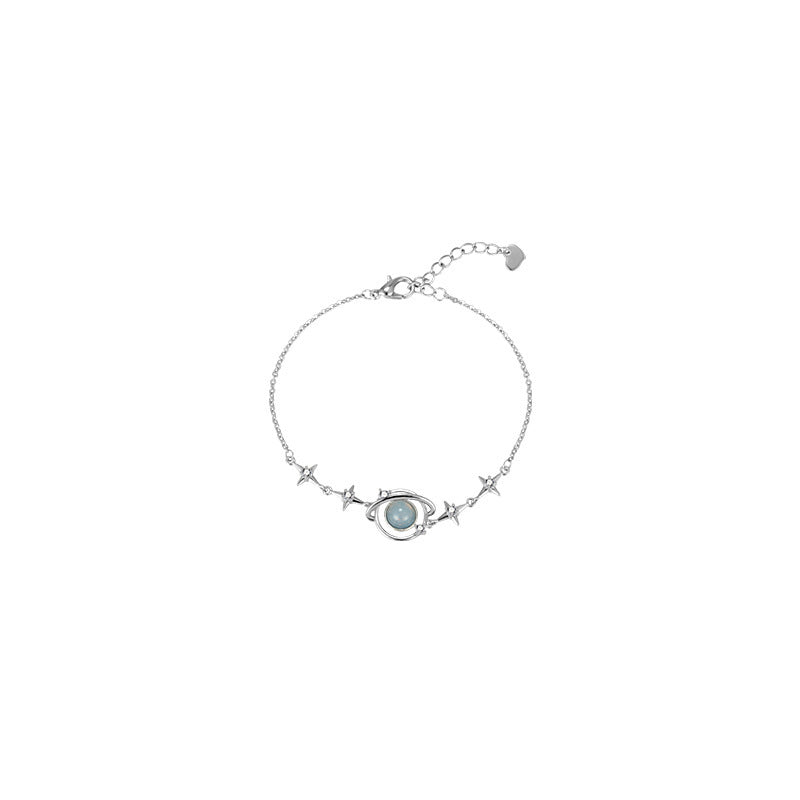 hands wearing blue planet bracelet