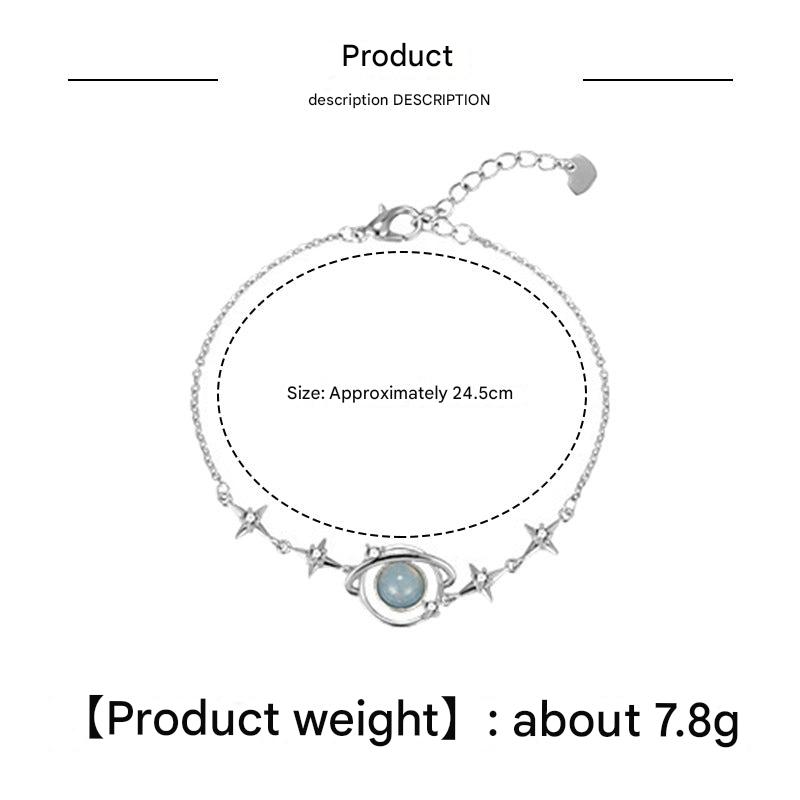 blue planet bracelet against a neutral background