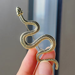 Snake brooch displayed on a jacket