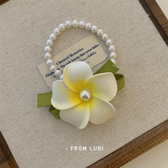 Cute floral hair clips on a wooden table