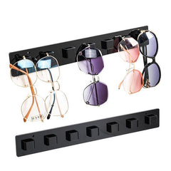 Black acrylic sunglasses rack showcasing various styles
