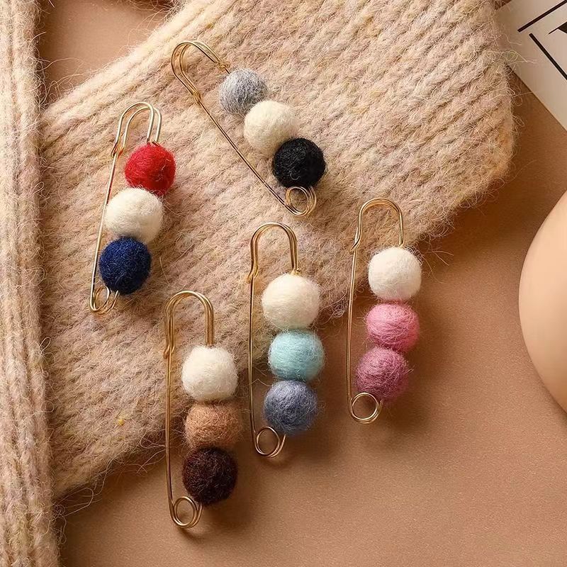 Close-up of adjustable cardigan brooch features
