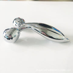 User rolling facial massager over skin