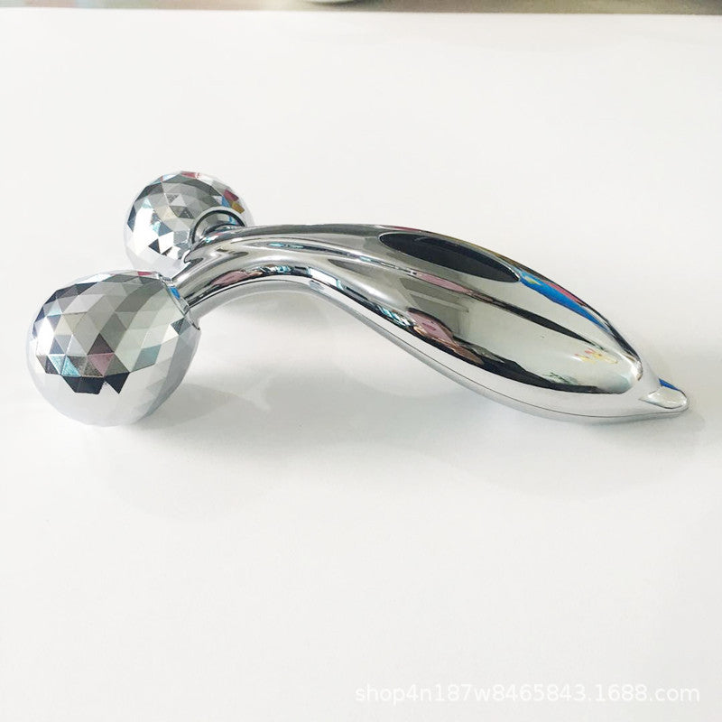 User rolling facial massager over skin