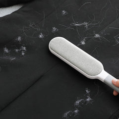 Double-sided hair brush displaying pet hair removal