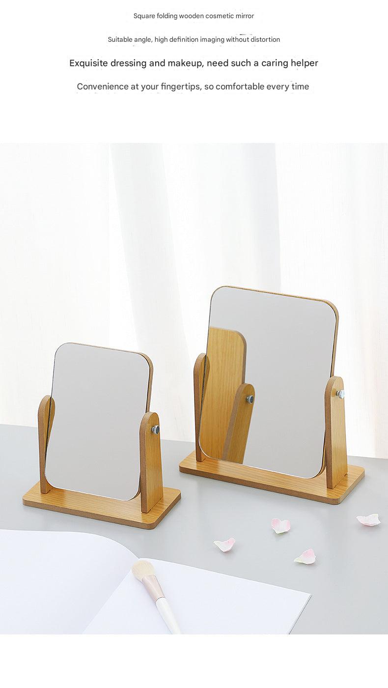 Adjustable wooden makeup mirror on desk with clear reflection