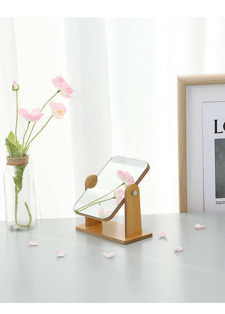 Adjustable wooden makeup mirror on desk with clear reflection