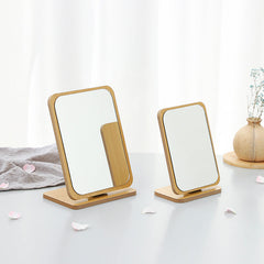 Close-up of foldable wooden makeup mirror with glass surface