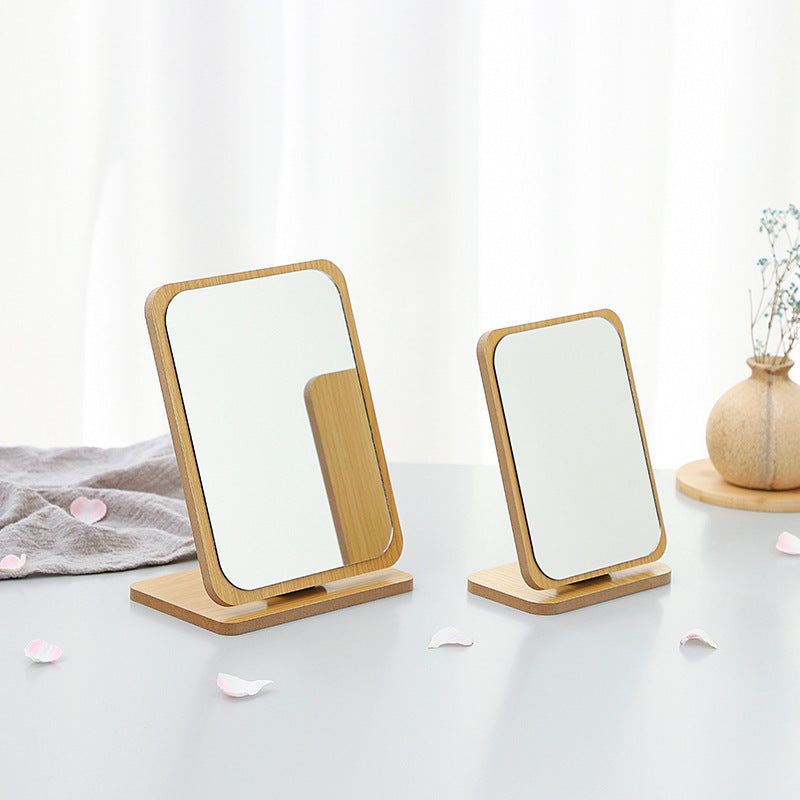 Close-up of foldable wooden makeup mirror with glass surface