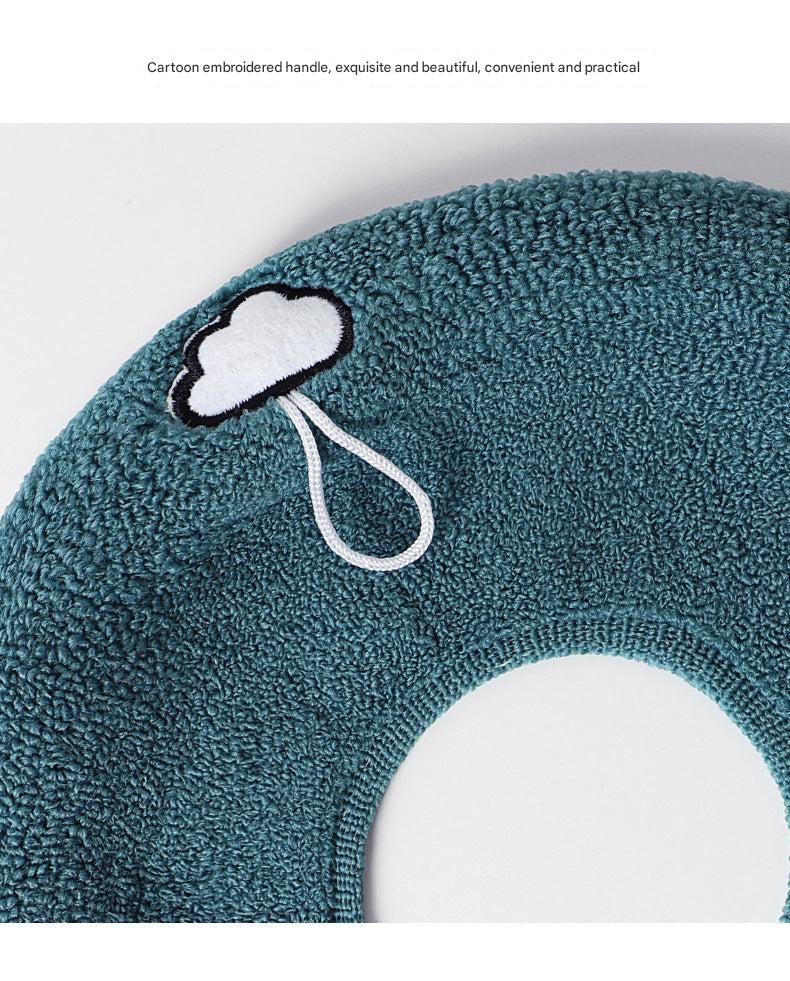 Stylish dark green toilet seat cover in a bathroom setting