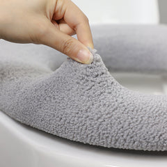 Stylish dark green toilet seat cover in a bathroom setting