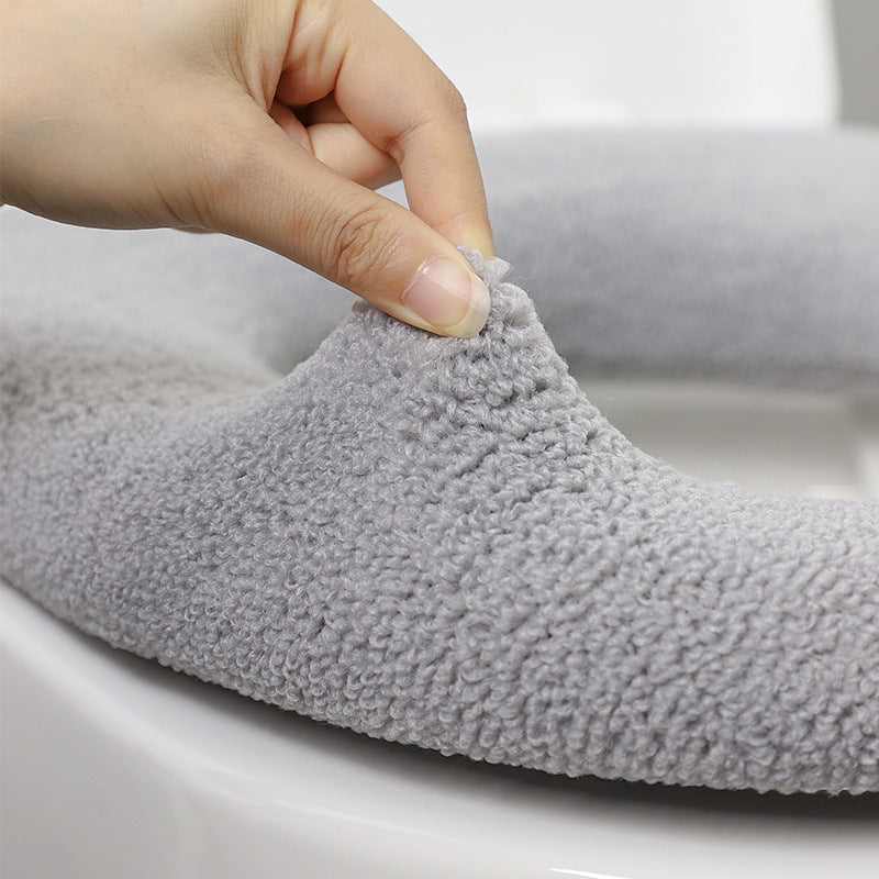 Stylish dark green toilet seat cover in a bathroom setting