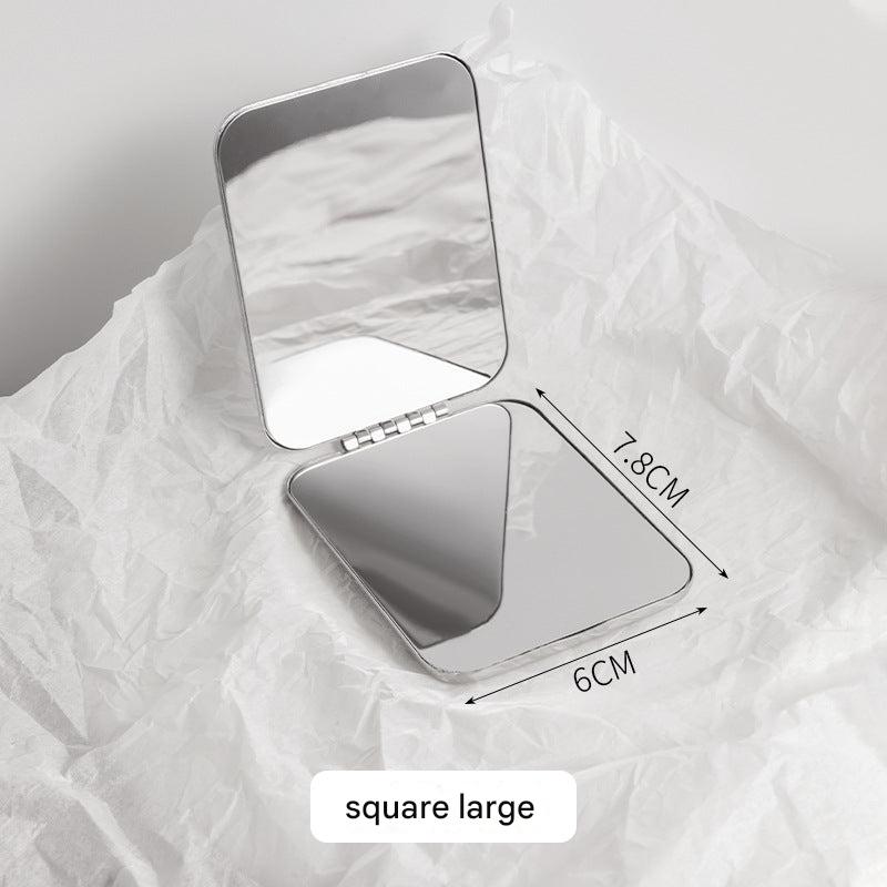 Round dual-sided mirror in stylish handbag