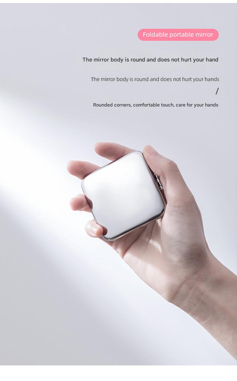 Hands holding a dual-sided mirror for touch-ups
