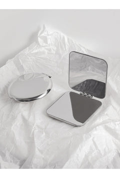 Stainless steel portable makeup mirror on table