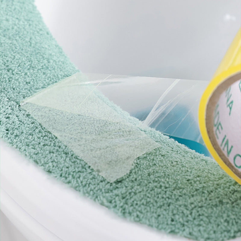 green plush toilet seat cover in bathroom
